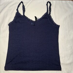 A cute navy blue tank top with the details of a bow & lace!